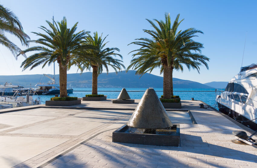 Palm trees, fountains and yachts on the embankment of Tivat, Montenegro