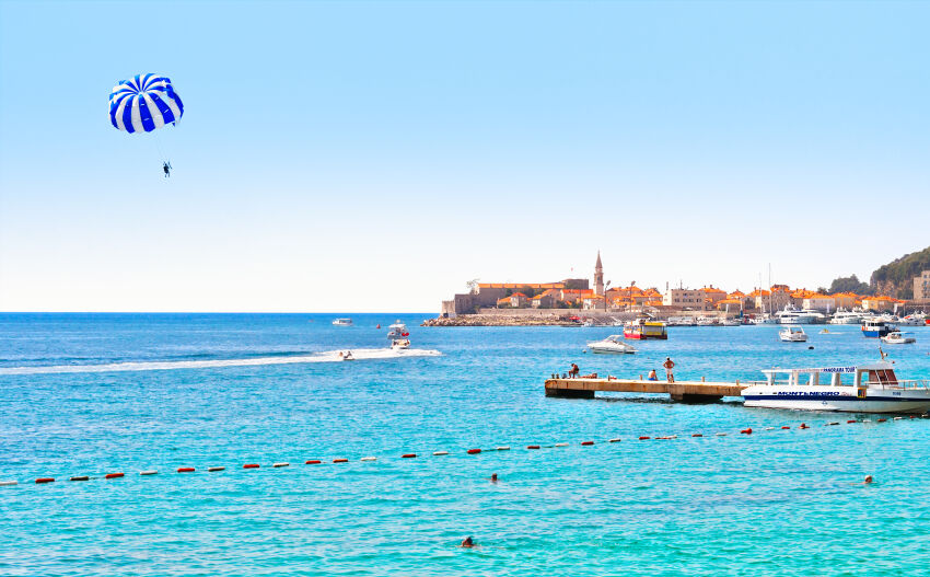 Parasailing over the sea with Budva in the background