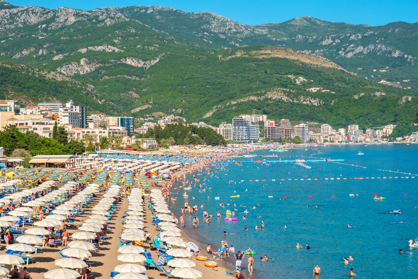 Becici beach, Montenegro, with numerous sun loungers and umbrellas